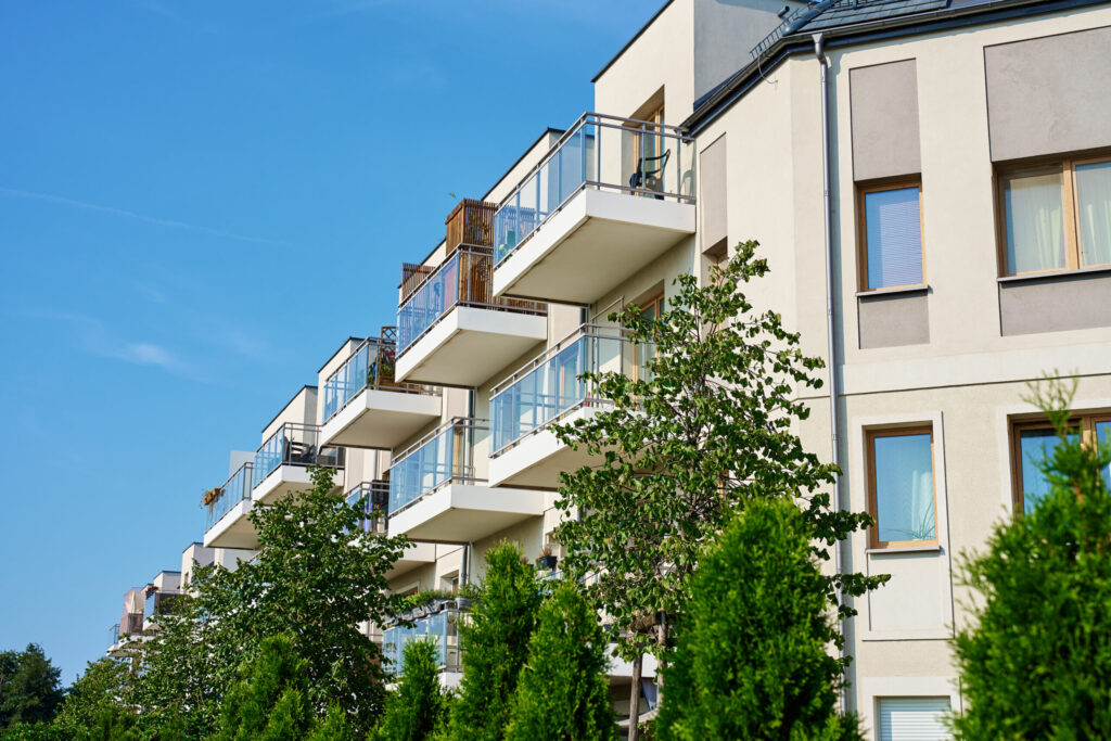 modern apartment building with balconies on sunny day